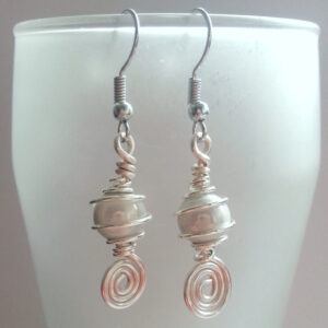 Handmade White Swirl Dangly Drop Earrings with Miracle Glow Beads – Elegant Wire Wrapped Artisan Jewellery