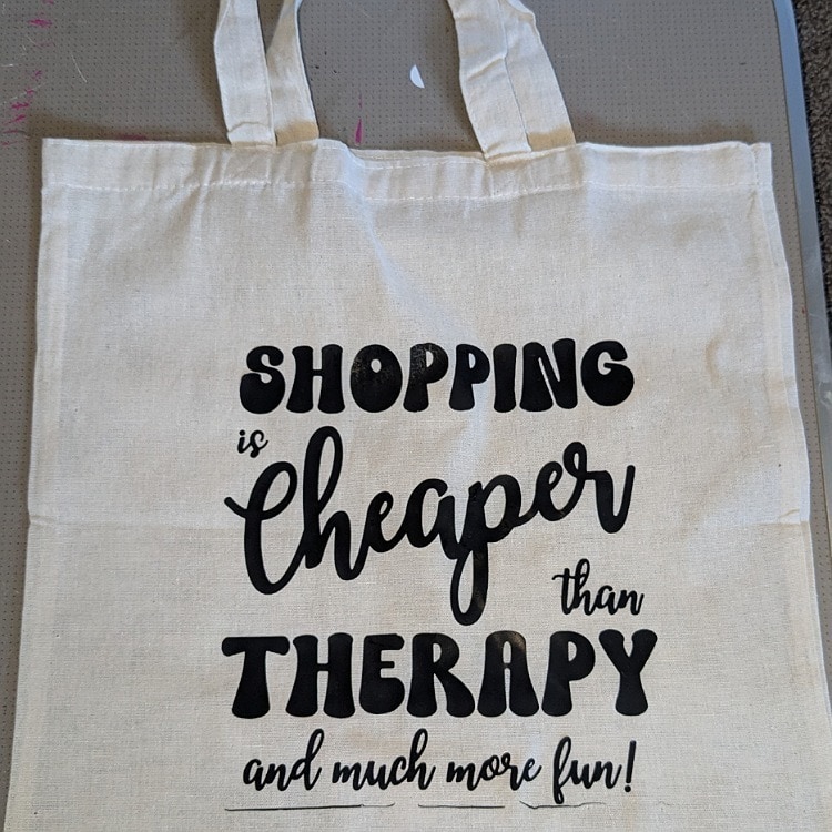 Shop sustainably with our natural recycled cotton tote bag featuring a motivational quote - Shopping is Cheaper Than Therapy