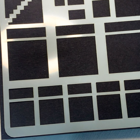image shows close up of mylar stencil for layout basics showing boxes, squares, oblongs and dividers.