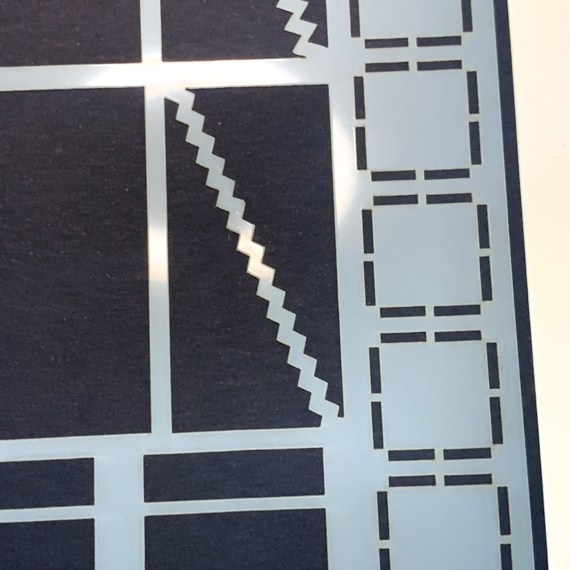 image shows close up of mylar stencil for layout basics showing boxes, squares, oblongs and dividers.