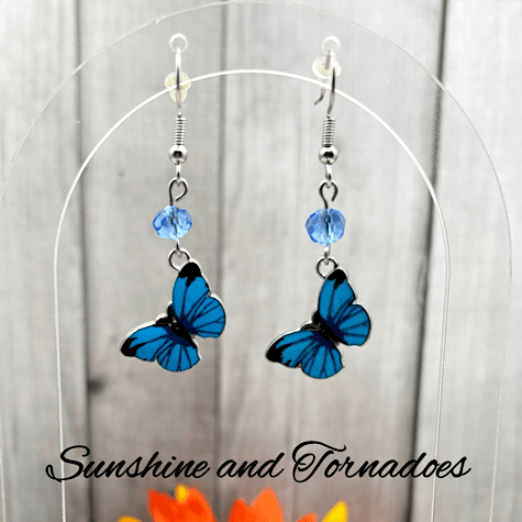 Handmade Blue Enamelled Silver Butterfly Drop Earrings with Pale Blue Faceted Glass Beads.