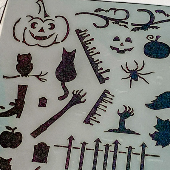 Magical Creatures Journal Stencil, Mythical wizardry Craft Stencil, Dragons, Fairies, witches, Pegasus, bats, cats, fairy, mermaids. Showing close up of zombie arm, perched owl, smiling pumpkin, cut out pumpkin with face, twisted branch, tombstone, witches boot, dripping lines of blood, grave rails, spider