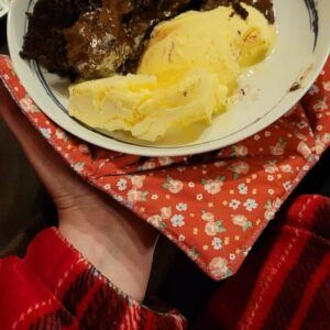 Person holding a Microwave-Safe Bowl Cosy with chocolate pudding.