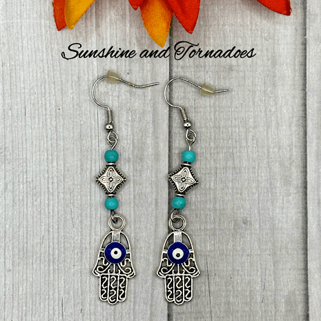 Handmade Drop Earrings with Silver Evil Eye Hamsa Charms and Turquoise Howlite Gemstone Beads. - Image 2