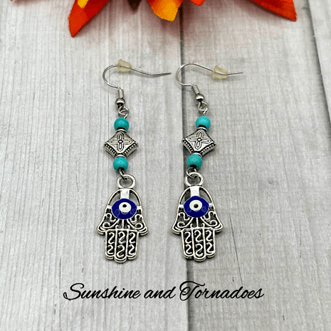 Handmade Drop Earrings with Silver Evil Eye Hamsa Charms and Turquoise Howlite Gemstone Beads.