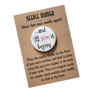 Round 38mm needle minder with a spool illustration and the text “and sew it begins,” featuring a strong magnet to hold needles, patterns, or small scissors.