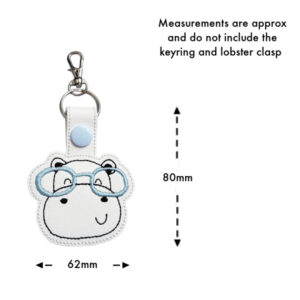 Happy Hippo with Glasses Keyring featuring an embroidered hippo face with light blue glasses on white faux leather, shown with approximate measurements of 80mm height and 62mm width, excluding the keyring and lobster clasp.