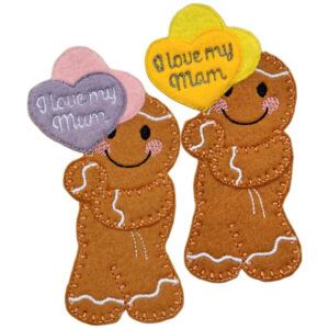 Pair of I Love My Mum and I Love My Mam Heart Balloons Gingerbread Characters made from brown felt, each holding embroidered heart-shaped balloons in pastel colours, with smiling faces and stitched icing details.