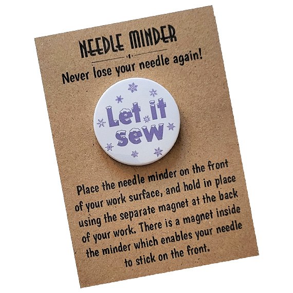 Magnetic needle minder for cross-stitch and embroidery, white background with snowflake design and “Let It Sew” text