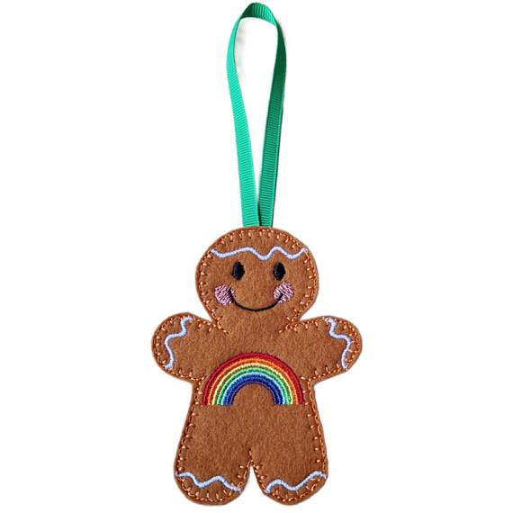 Rainbow Smiles Gingerbread Character – male version. A cheerful felt gingerbread decoration with a vibrant embroidered rainbow across its front, smiling face, and white icing details, finished with a green ribbon loop for hanging.