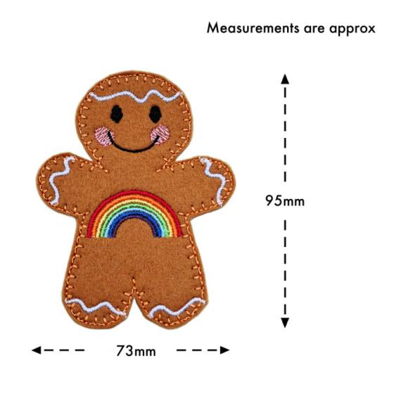 Rainbow Smiles Gingerbread Character – a cheerful felt gingerbread figure with a vibrant embroidered rainbow across its front, smiling face, and white icing details. Measurements are approximately 95mm tall and 73mm wide.