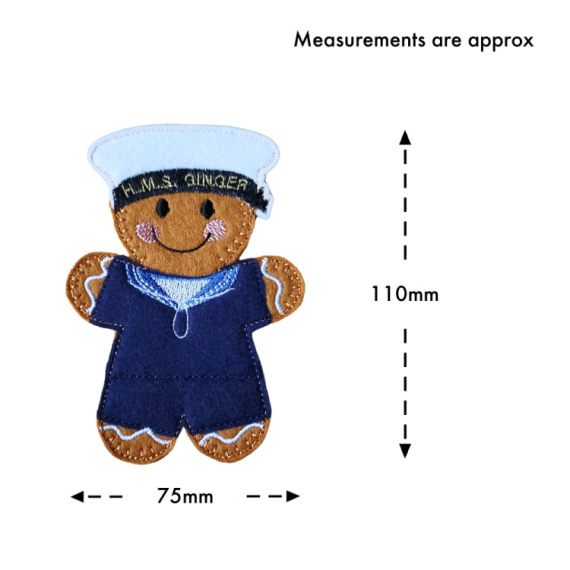 Royal Navy Sailor Gingerbread Character wearing a dark blue uniform with a light blue collar and a white sailor’s cap embroidered with the words ‘HMS GINGER.’ The character is shown with approximate measurements of 110mm tall by 75mm wide.