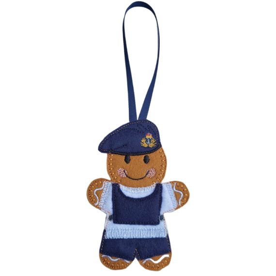 Royal Navy Submariner Gingerbread Character figure dressed in a dark blue uniform with light blue details and a matching beret embroidered with an insignia. Finished with a dark blue ribbon loop for hanging.
