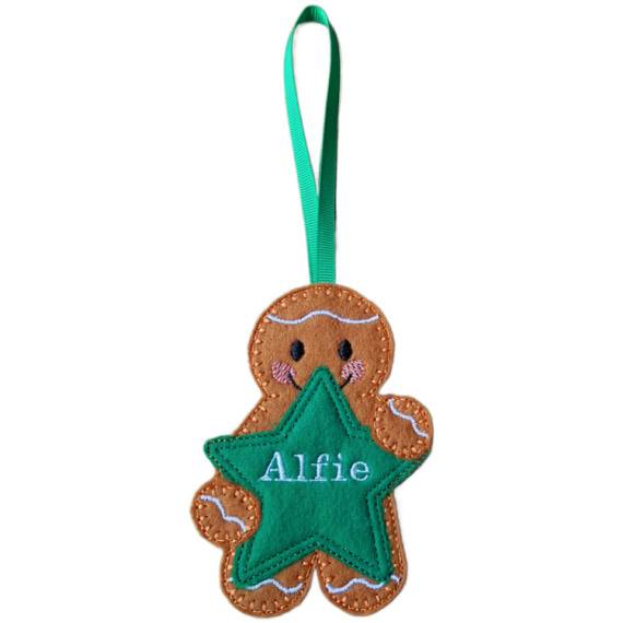 Handmade felt gingerbread character holding a green star with embroidered name ‘Alfie.’ Finished with a green ribbon loop for hanging.