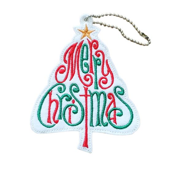 Tree-shaped white felt ornament embroidered with the words ‘Merry Christmas’ in swirling red and green script, topped with a golden star. Finished with neat stitching and a silver ball chain loop for hanging.