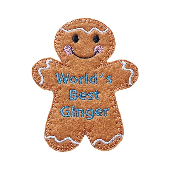 World’s Best Ginger Gingerbread Character — a handmade felt gingerbread figure with a smiling face, rosy cheeks, and embroidered text that reads “World’s Best Ginger.”