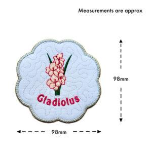 Embroidered scalloped gladiolus candle coaster shown with measurement guide, indicating approximately 98mm in both width and height, with arrows marking the dimensions.