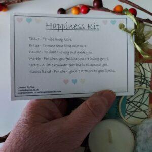 Picture shows close up of card on front of bag of contents for the Happiness kit