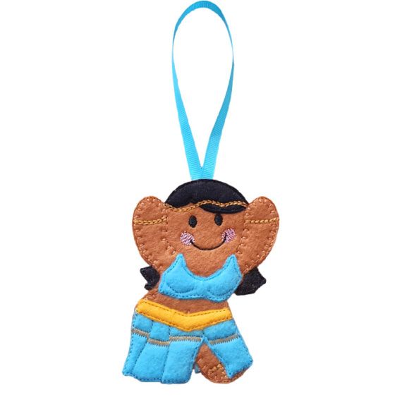 A felt gingerbread belly dancing girl hanging decoration with a turquoise ribbon loop, featuring raised arms, black hair, a turquoise stitched top, and a flowing turquoise skirt with a yellow belt.