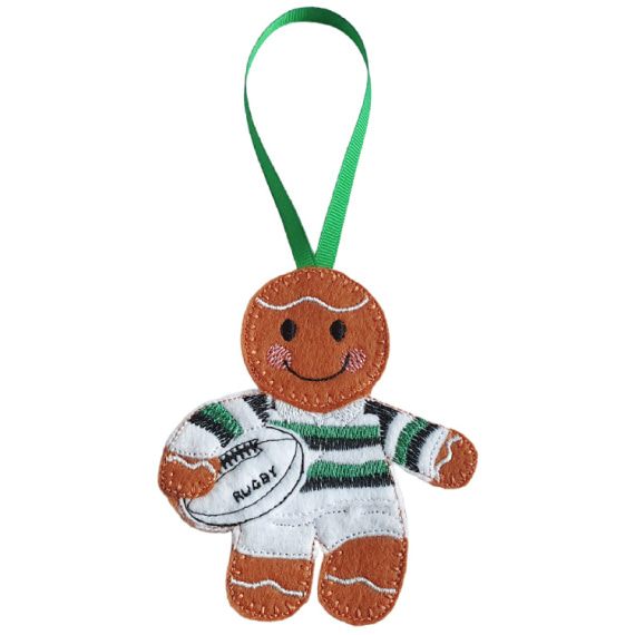 Felt gingerbread rugby player character wearing a white and green striped kit, holding a white rugby ball stitched with the word “Rugby,” shown with a green ribbon loop for hanging.