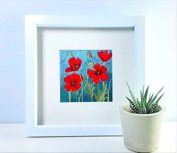 ed poppies embroidery with silk threads mounted in a white box frame