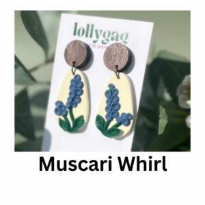 Handmade muscari flower polymer clay earrings with curved sculptural shape in blue, green and cream, finished with wood studs, made in Sheffield UK
