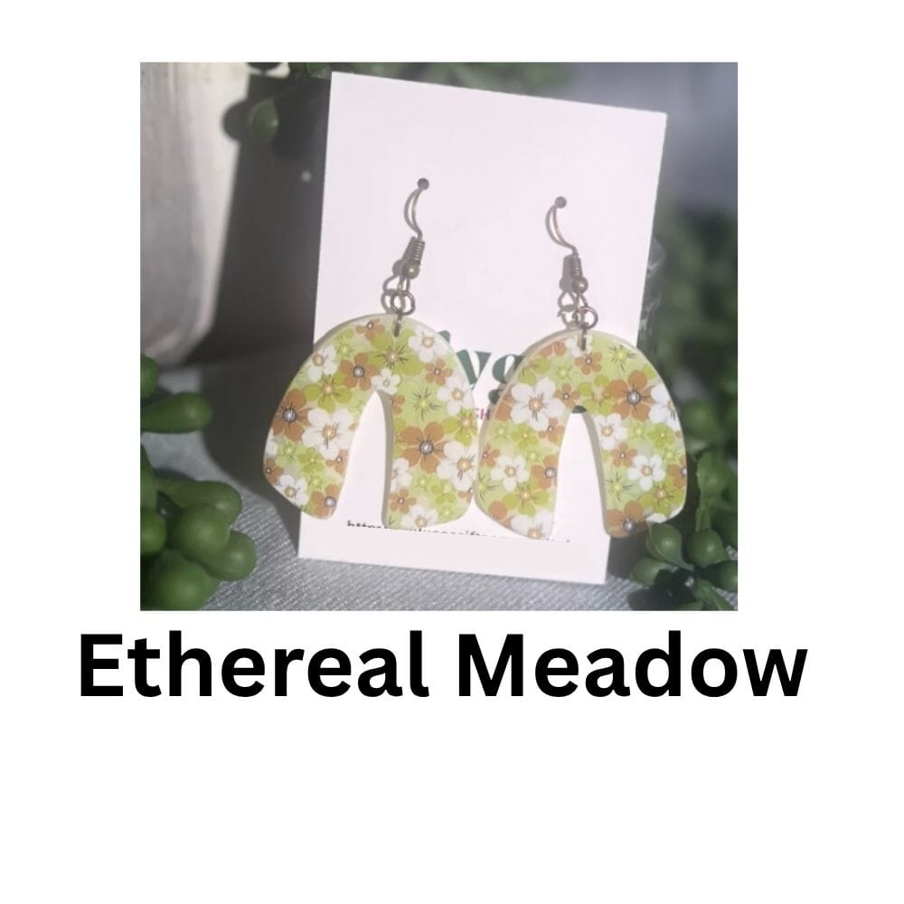 Ethereal Meadow polymer clay earrings with translucent arched drops printed with tiny daisies and wildflowers, handmade in Sheffield.