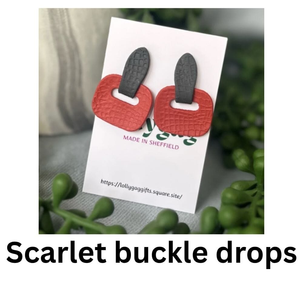Scarlet red textured polymer clay earrings with grey strap-style tops, designed to resemble modern buckle details, handmade by Lollygag.