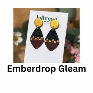 Emberdrop Gleam diamond-shaped polymer clay earrings with faux wood texture, matte black detail and gold inlay dots, handmade in Sheffield by Lollygag Jewellery.