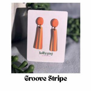 Retro striped drop earrings handmade from polymer clay in burnt orange and caramel tones, lightweight 70s inspired statement earrings handmade in Sheffield UK