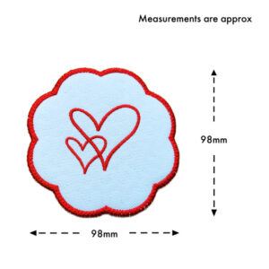 Mini white scalloped table mat with a red embroidered heart design, shown with dashed arrows indicating approximate measurements of 98 mm wide and 98 mm high, with text reading “Measurements are approx.”