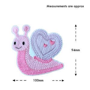 Smiling felt snail with a heart-shaped shell, machine embroidered with a knit stitch pattern, shown on a white background with approximate measurements of 100mm wide and 94mm tall.