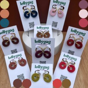 Handmade polymer clay spiral hoop earrings inspired by the Pantone Autumn Winter colour palette, featuring earthy tones including Lemon Grass, Brandied Melon, Lyons Blue, Damson, Winterberry, Hot Chocolate, Chili Oil, Poppy Red and Bronze Brown, displayed on Lollygag jewellery cards.