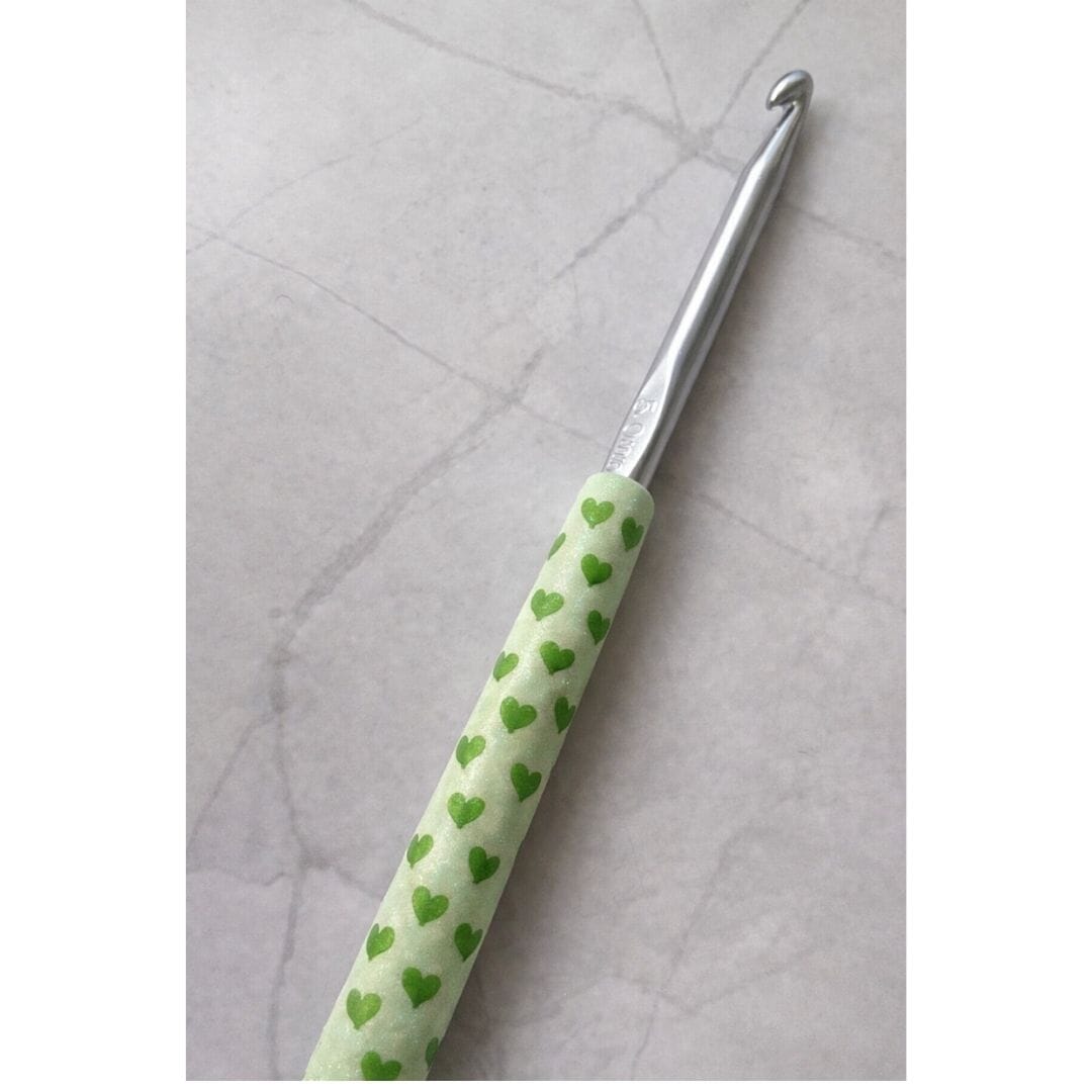 Handmade polymer clay handled crochet hook with green heart pattern, Moments of Love limited edition Valentine’s Day gift by Lollygag Sheffield