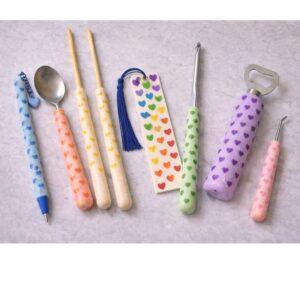 Handmade polymer clay handled craft tools with rainbow heart patterns including loom hooks, crochet hooks, spoon, pen, chopsticks and bookmark, Moments of Love limited edition Valentine’s Day gift by Lollygag in Sheffield