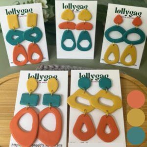Group photo of handmade polymer clay earrings in mustard yellow, coral orange and teal from the 1960s Decade Collection by Lollygag, inspired by dopamine dressing and handmade in Sheffield