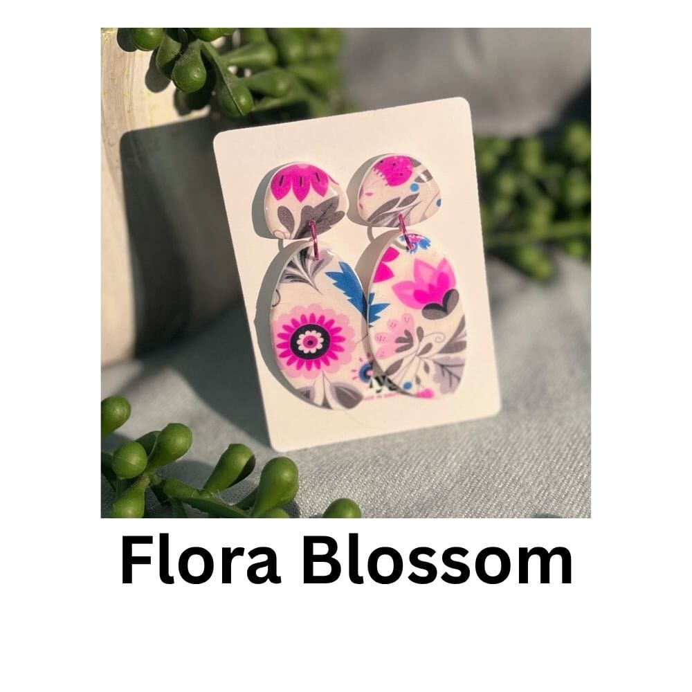 Flora Blossom earrings featuring rounded polymer clay drop shapes with vibrant hot pink and pastel 1970s floral wallpaper patterns, handmade by Lollygag Jewellery.