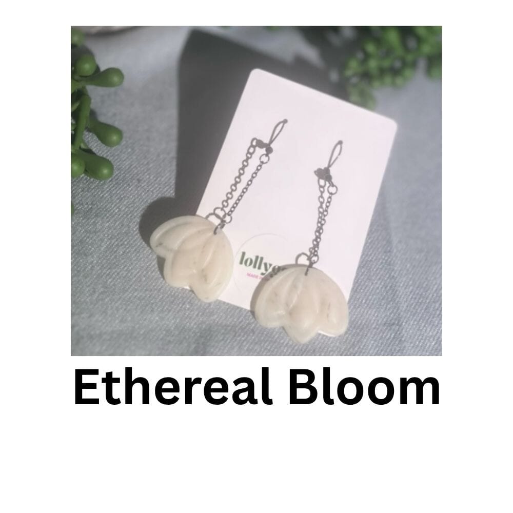 Ethereal Bloom polymer clay earrings with sculpted white floral forms suspended from black chain links, lightweight and handmade in Sheffield.