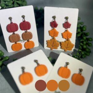 Harvest Glow Collection handmade polymer clay autumn earrings featuring pumpkin and maple leaf designs in orange, terracotta and red tones, handmade in Sheffield by Lollygag Jewellery.