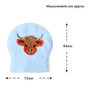 Single felt Highland cow tealight cover in white fabric with central embroidered cow head, shown with measurement guide indicating approximately 75mm width and 84mm height.