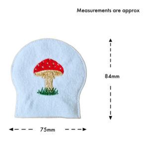 Single felt toadstool tealight cover with embroidered mushroom design, shown with measurement guide indicating approximately 75mm width and 84mm height.