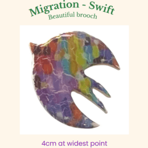 Abstract swift bird brooch with a glossy multicoloured pattern in purple, green, blue, and amber, handmade by Lollygag.