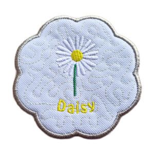 Embroidered daisy candle coaster with scalloped edge, featuring a single white daisy with a yellow centre and green stem on a white background.