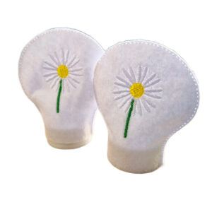 Set of two embroidered daisy tealight covers made from white felt, each featuring a single white daisy with a yellow centre and green stem, designed to fit over LED tealights.