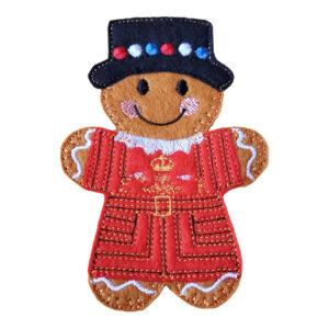 Beefeater Gingerbread Character made from felt, wearing a red and gold Tudor-style uniform and black hat with colourful embroidered dots.