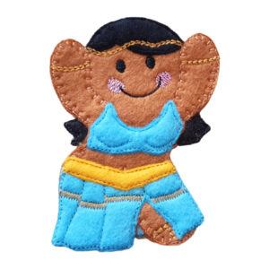 A smiling felt gingerbread girl dressed as a belly dancer, with raised arms, black hair, a turquoise stitched top, and a flowing turquoise skirt with a yellow belt.