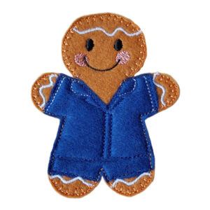 A small handmade felt carer gingerbread character with embroidered black eyes, a smiling mouth, pink cheeks, and decorative icing details. The figure is dressed in a stitched navy blue uniform and is displayed on a clean white background.