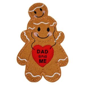 Handmade felt Dad and Me Gingerbread Character showing a large gingerbread figure with a small child on top, both smiling, holding a red heart embroidered with “Dad and Me.”