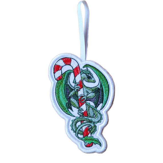 Handmade embroidered dragon Christmas ornament wrapped around a red and white candy cane, with green wings and hanging from a white ribbon loop.