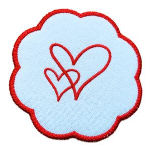 Embroidered candle coaster with a scalloped red edge, featuring a simple red outline of two overlapping hearts on a white background.